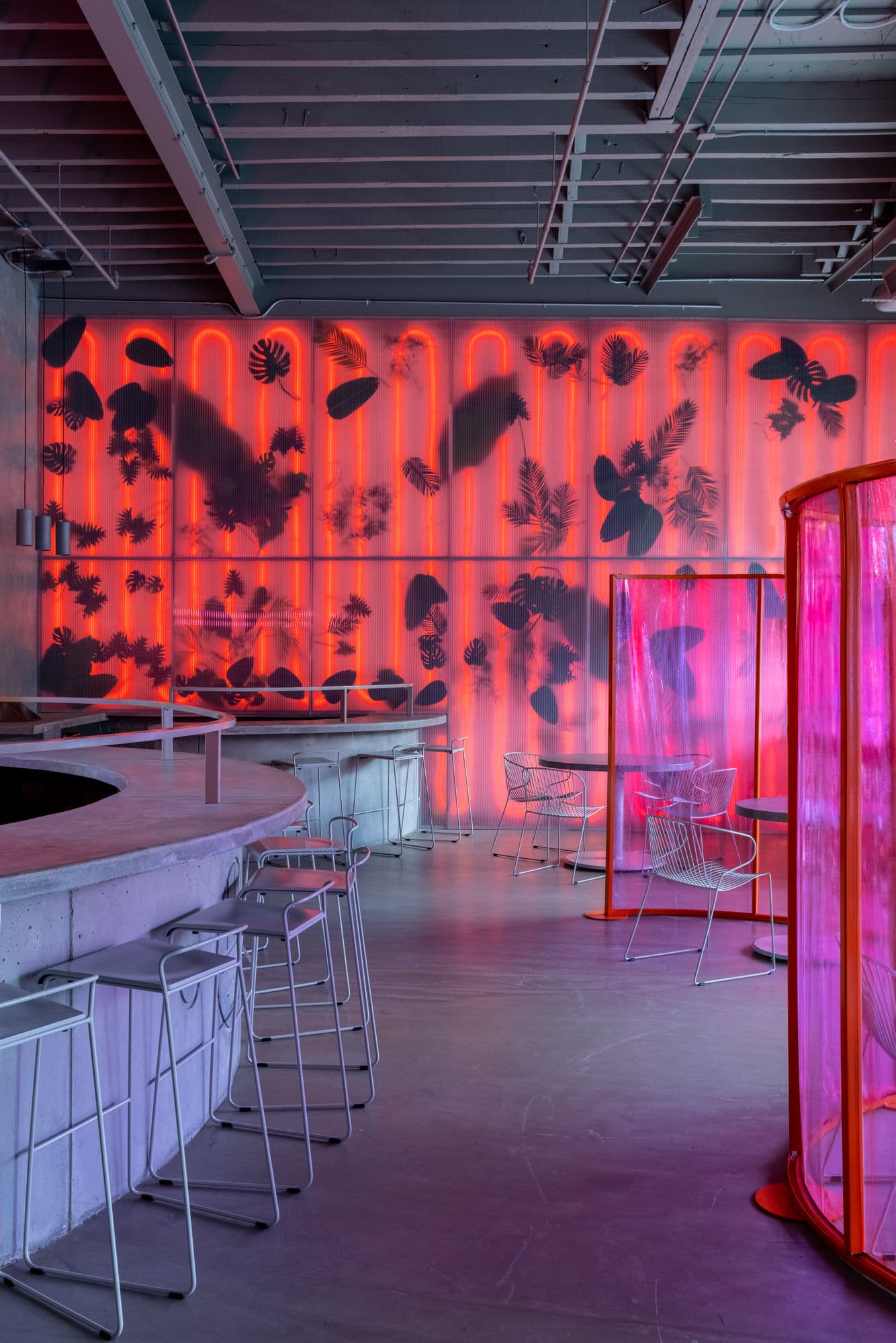 Bar interior with red neon leaf wall